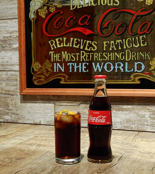 Old Coke bottle and vintage Coke sign.